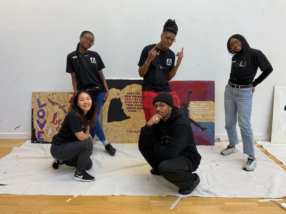 A group of young people creating merals